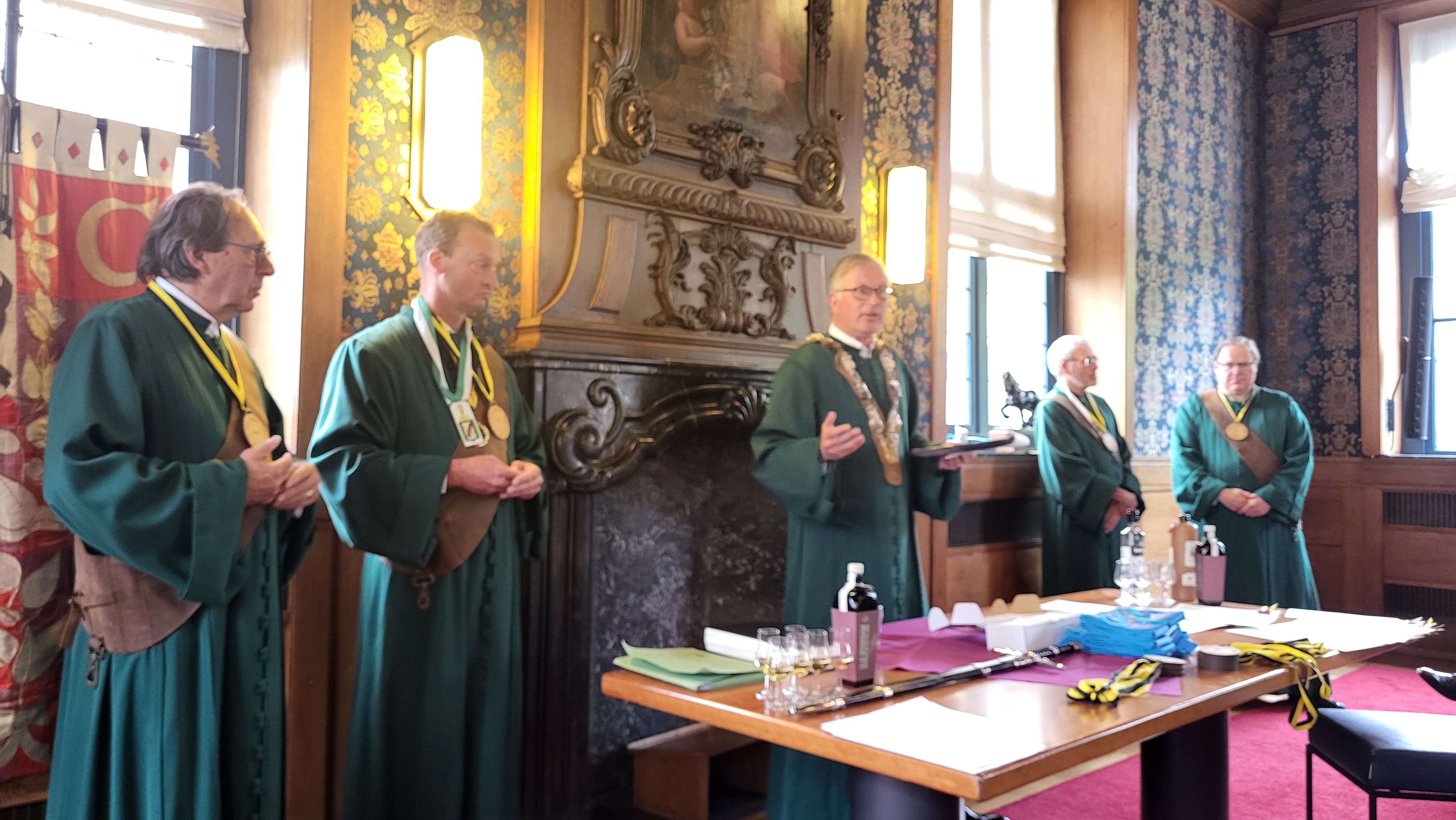JW in gesprek met deken, nieuwe gezel en ridder van Jenevergilde